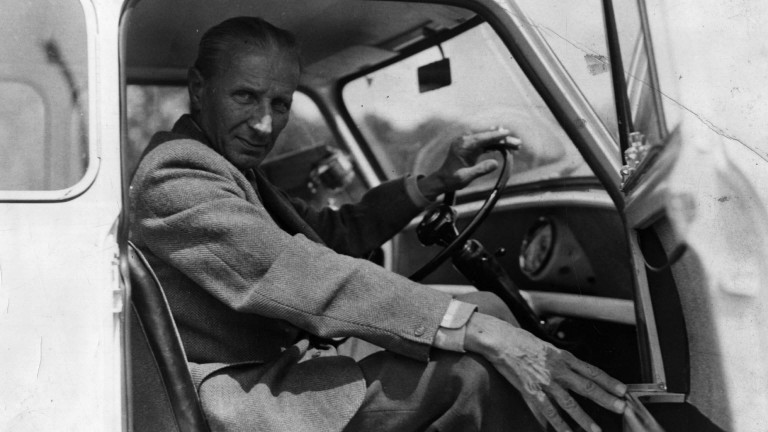 Sir Alec Issigonis behind the wheel of a Mini Morris-Minor..