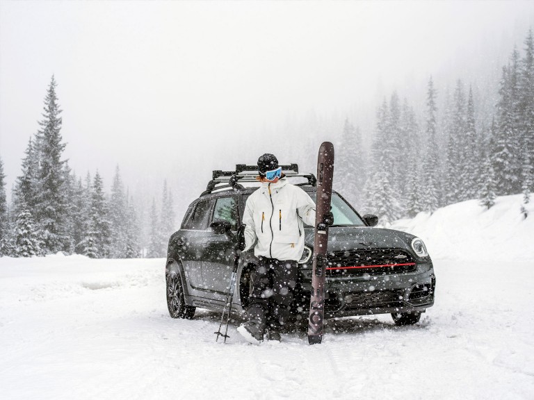 Professional Big Mountain skier Cole Richardson standing in front of a MINI John Cooper Works Countryman ALL4.