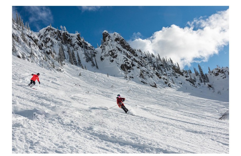 Image of two “Silver Sliders” who are skiing down the Canadian mountains. 