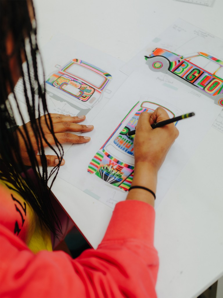 At work in her studio: Lakwena is sketching the design concept for her classic Mini. Her basic tools for the job: pen and paper.